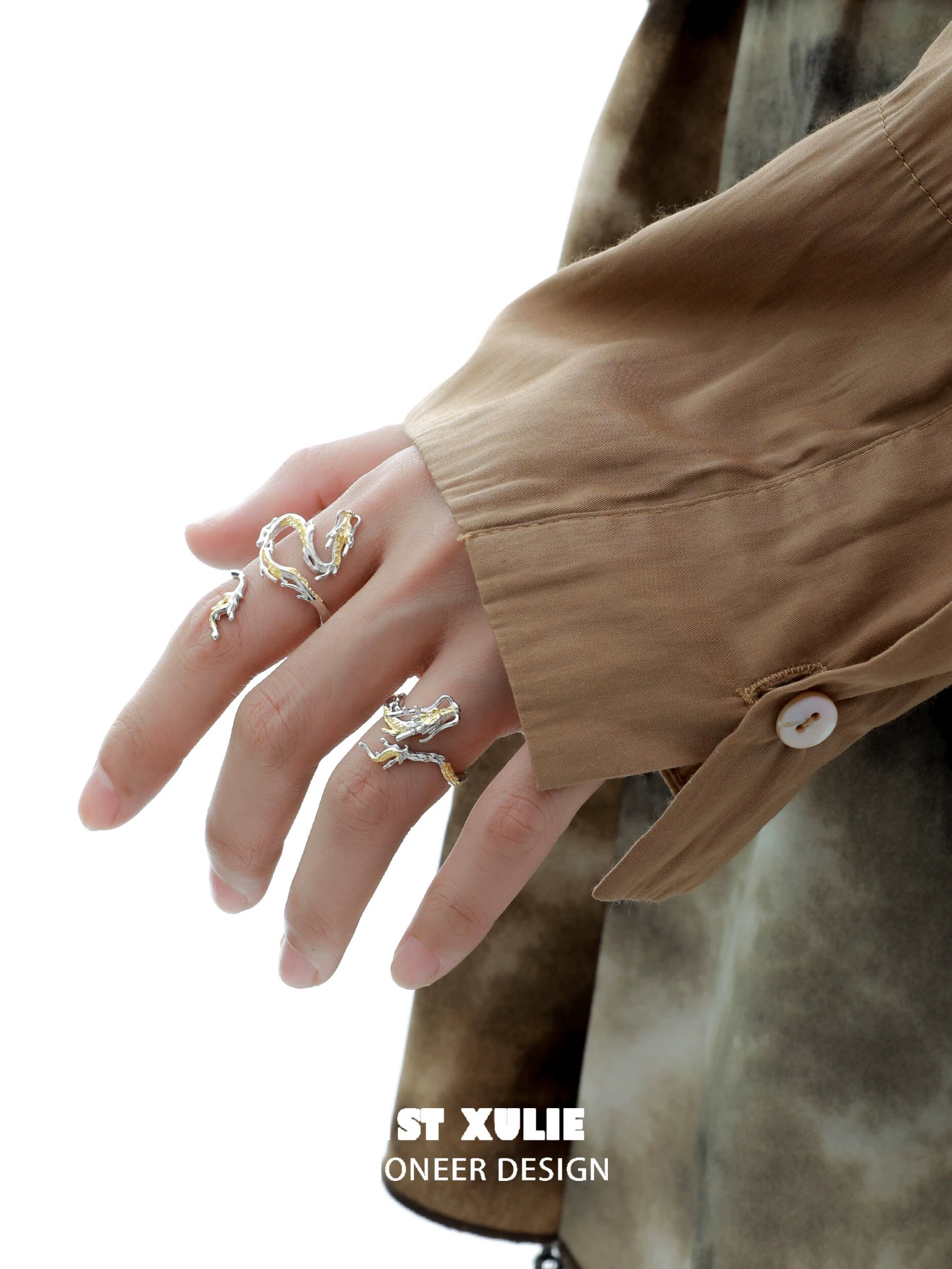 Gold dragon wrap silver ring elegantly displayed on a hand with stylish attire