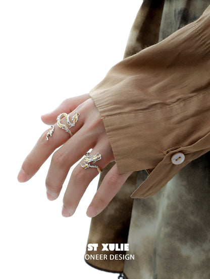 Gold dragon wrap silver ring elegantly displayed on a hand with stylish attire