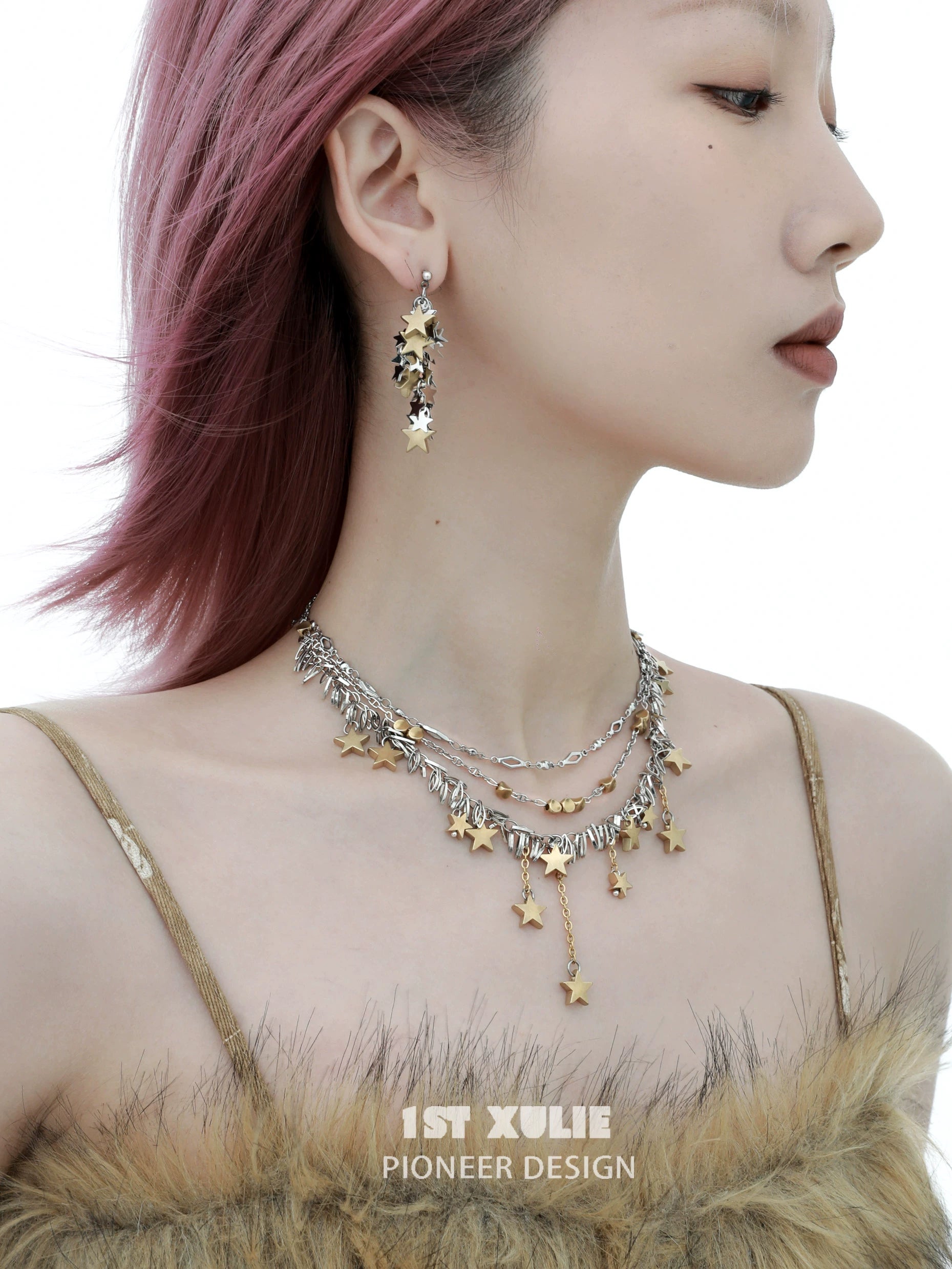 Gold star tassel necklace layered with silver accents, perfect for stylish accessorizing