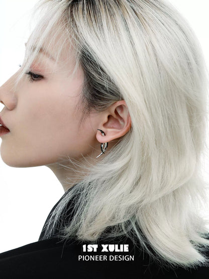 Y2K moon earrings displayed on a model with silver hair and a chic hairstyle