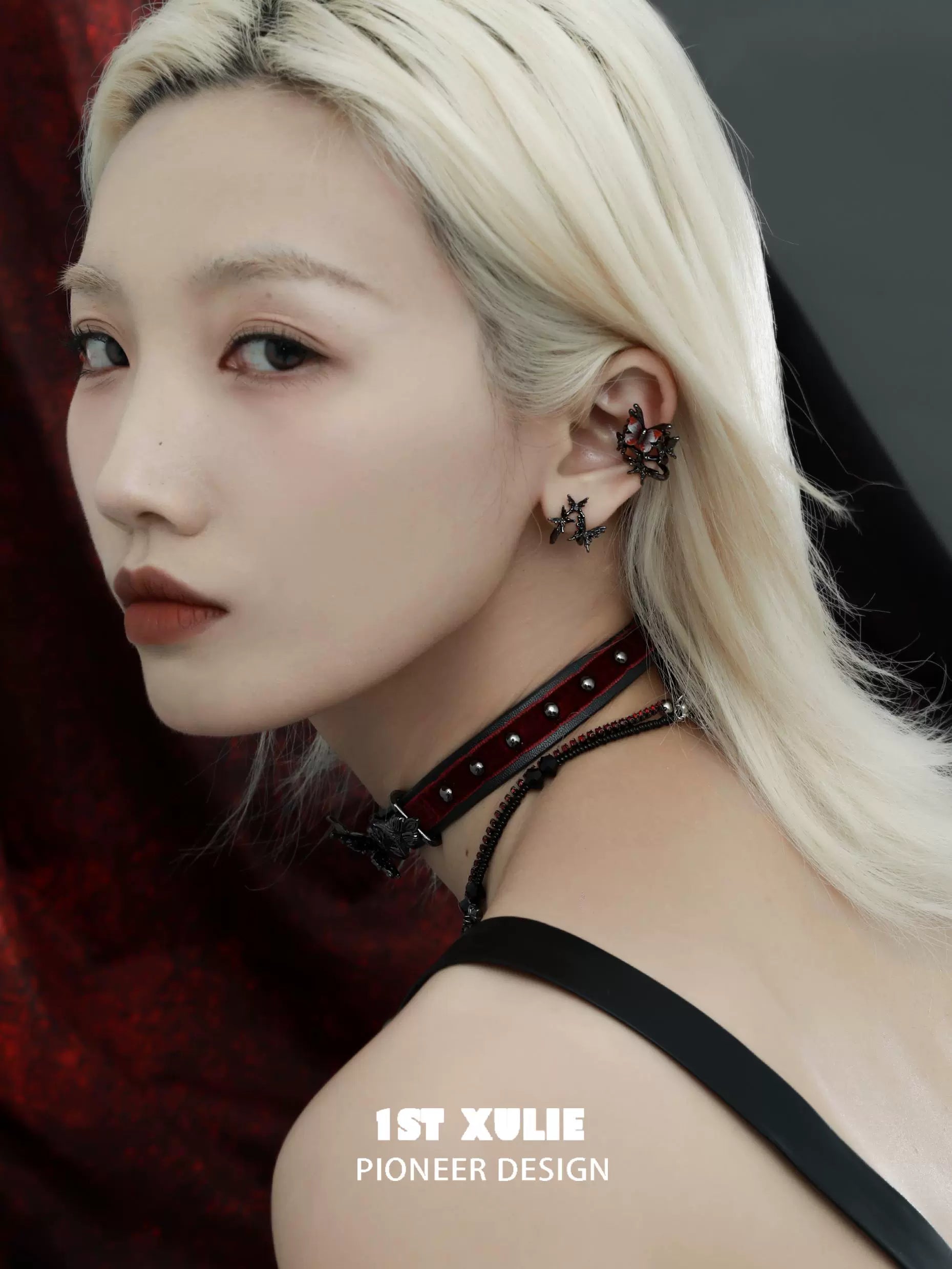 Gothic butterfly ear clip showcased on model with platinum hair and stylish choker