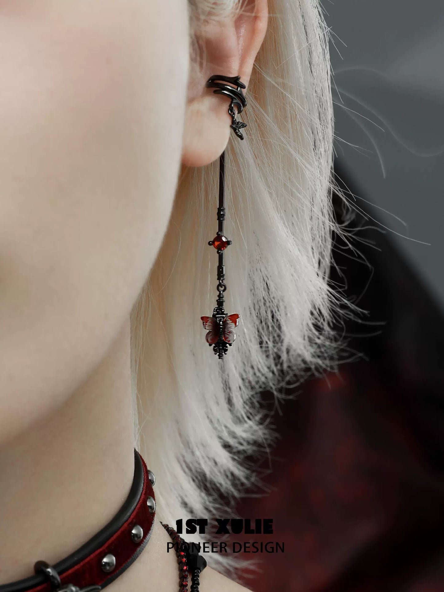Gothic butterfly earrings featuring black and red designs with dangling elements for a unique style