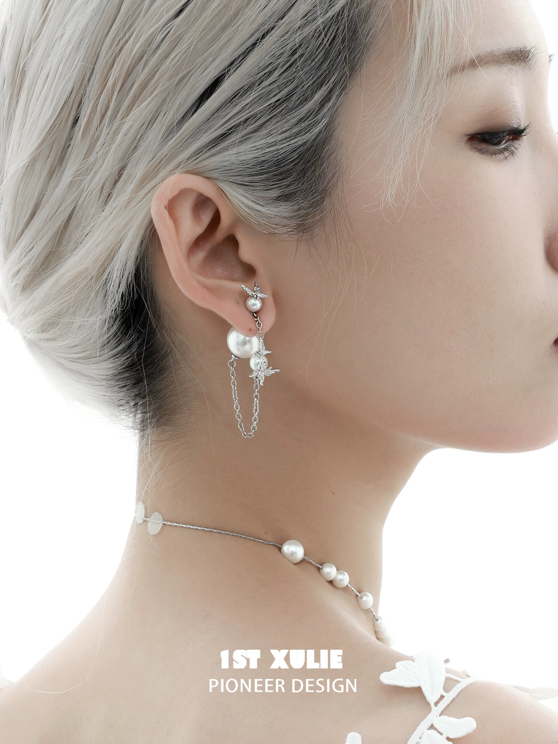 Gothic butterfly earrings featuring pearls and chains, styled for a trendy look