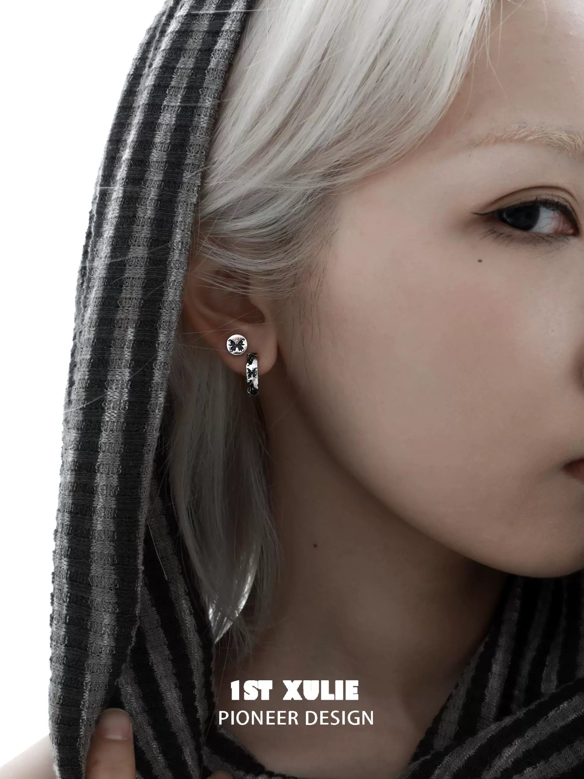 Model wearing gothic butterfly earrings with a stylish design, highlighting unique details and fashion appeal