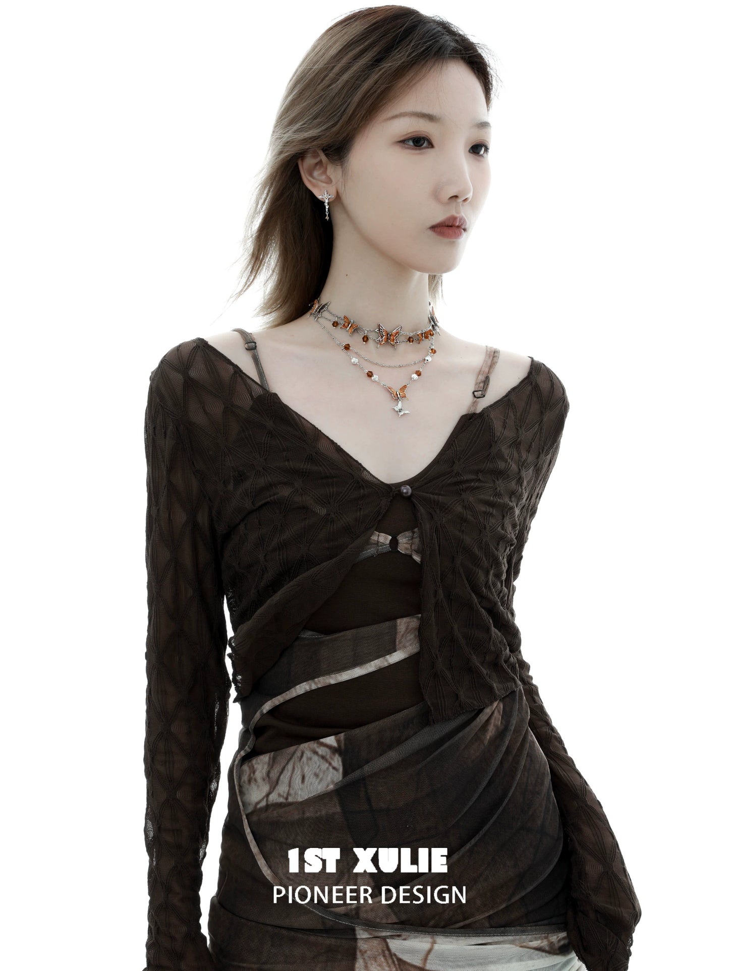 Gothic butterfly necklace worn by a model showcasing a stylish outfit in an artistic setting