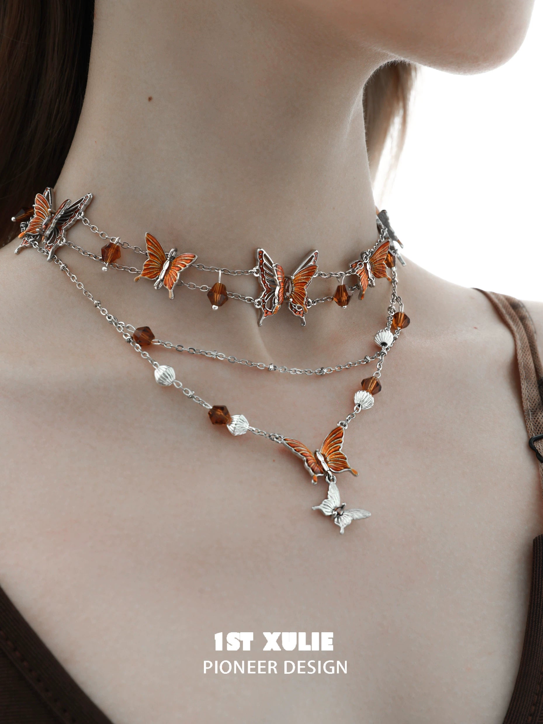 Gothic butterfly necklace featuring silver chains and orange butterfly charms for a unique accessory