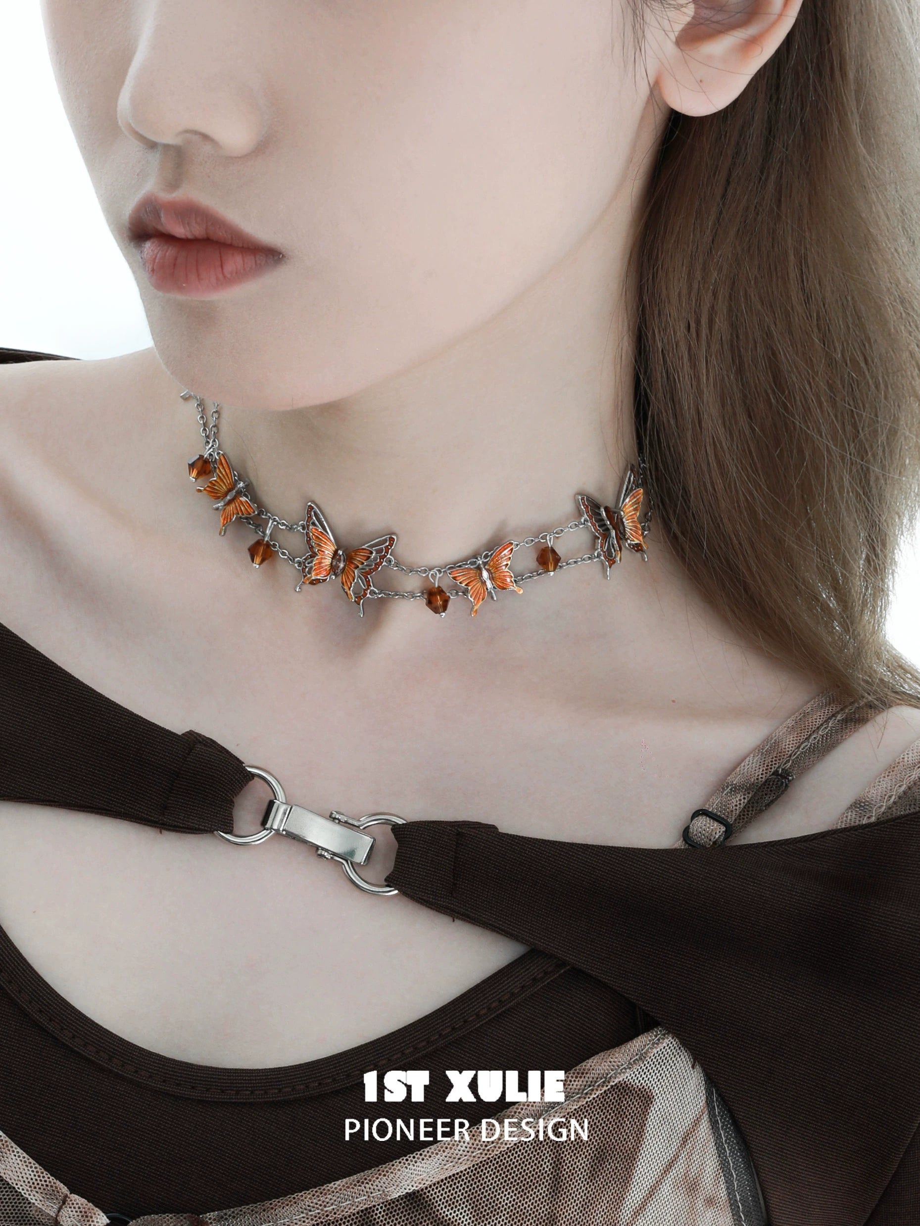 Gothic butterfly necklace adorned with orange gemstones on a silver chain for a trendy look