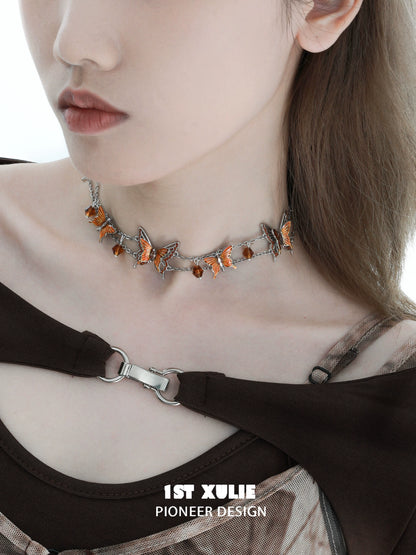 Gothic butterfly necklace adorned with orange gemstones on a silver chain for a trendy look