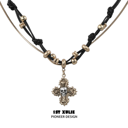 Gothic cross necklace by 1STXULIE featuring a unique skull pendant and intricate bead details
