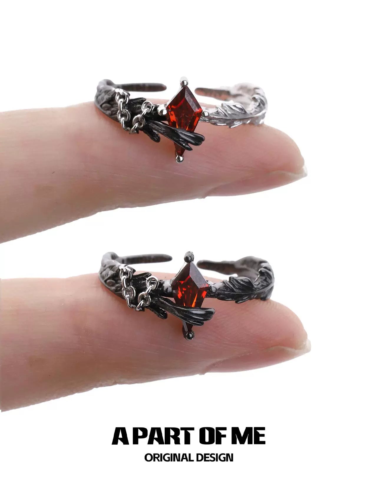 Gothic feather ring by A PART OF ME featuring a red gemstone and intricate design on a finger
