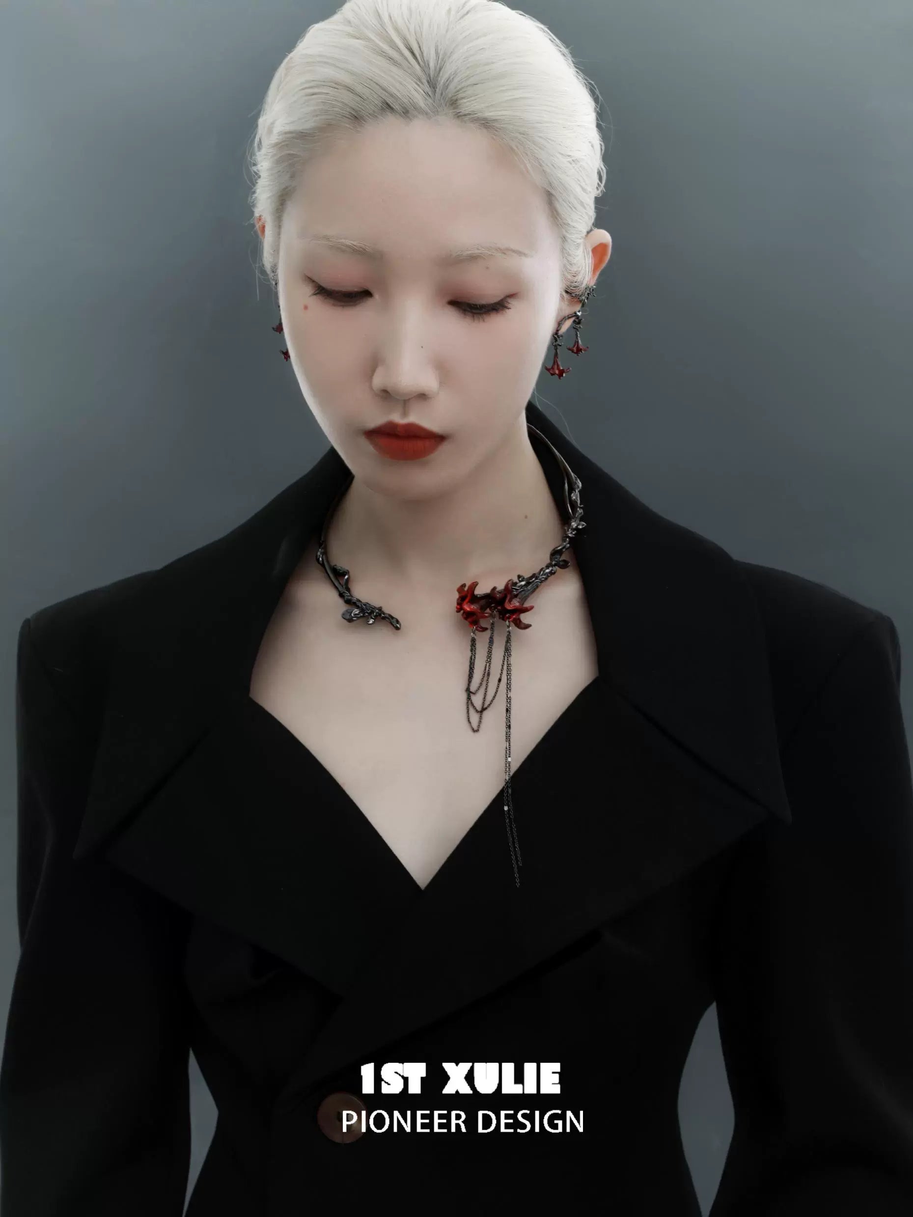 Fashion model showcasing gothic mandala ear cuffs paired with a stylish black coat
