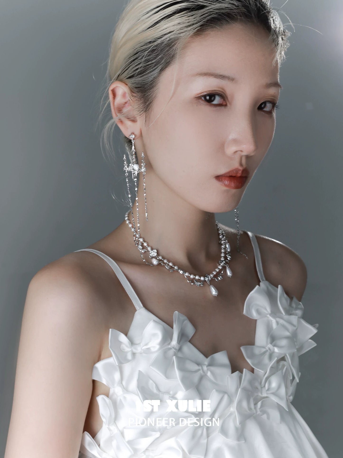 Elegant gothic rose tassel earrings featured on a model with a stylish white outfit