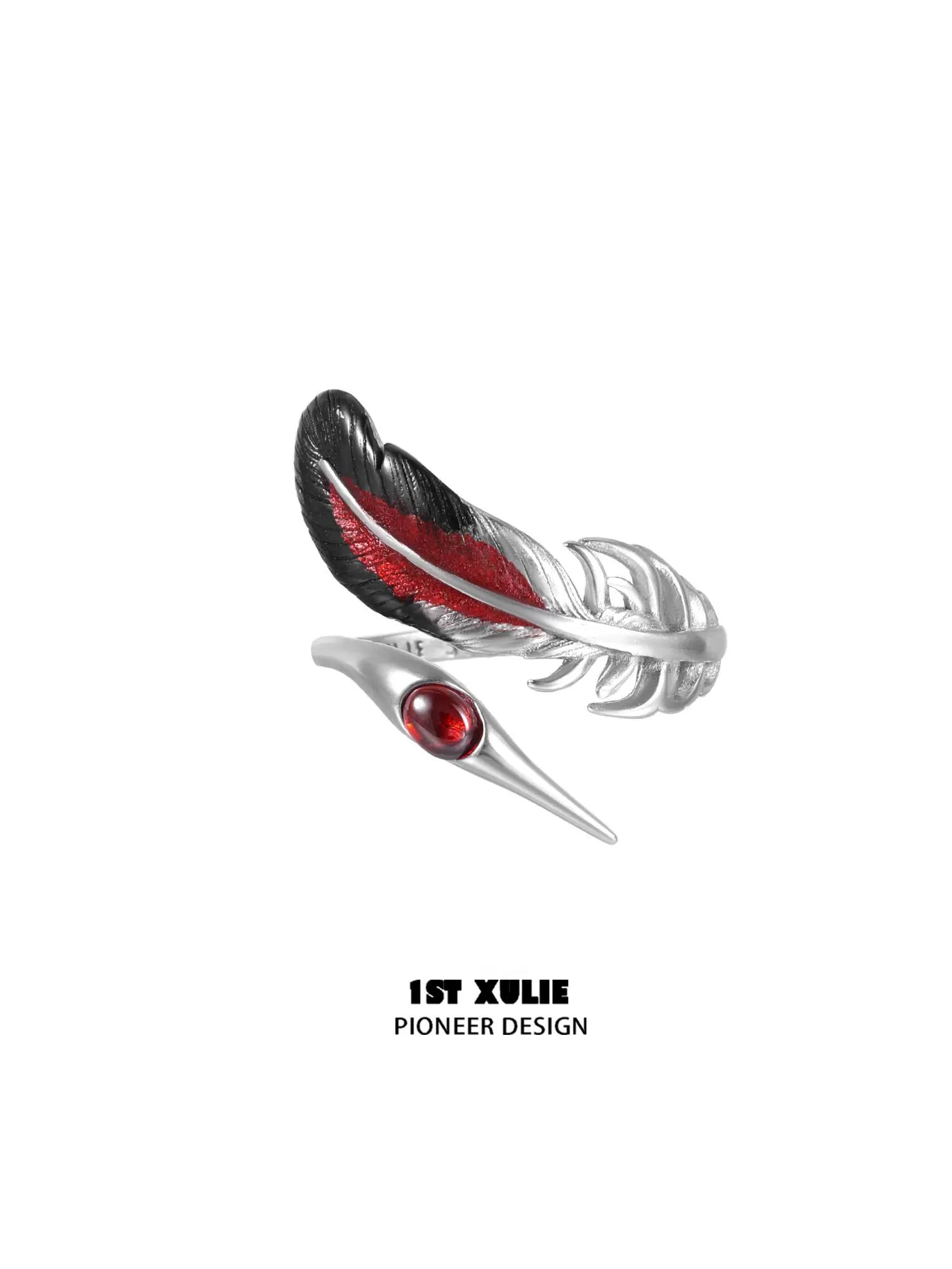 Gothic silver crane ring featuring a feather design with red accents and a gemstone