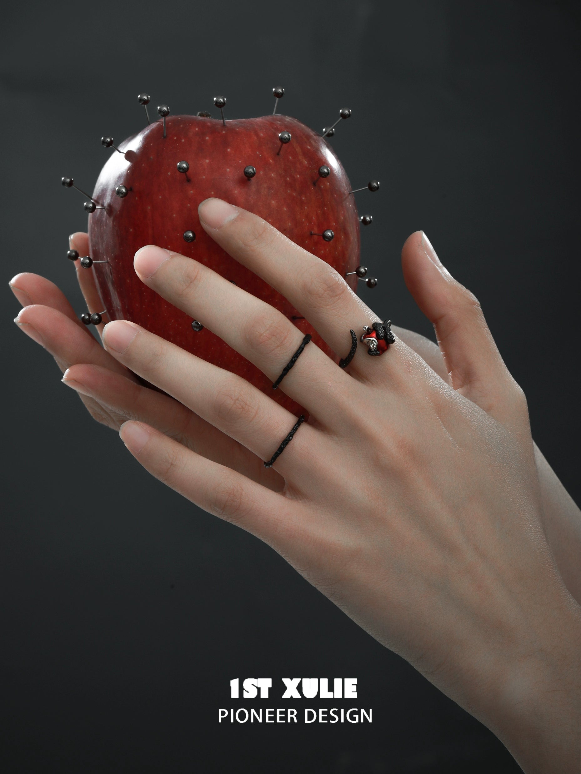 Gothic snake apple ring displayed on hand with a decorative apple for a dramatic look