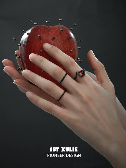 Gothic snake apple ring displayed on hand with a decorative apple for a dramatic look