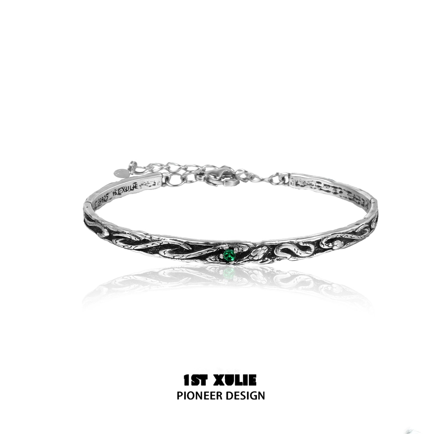 Intricate gothic snake bracelet featuring a silver design with a green gemstone accent