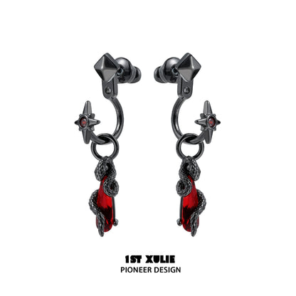 Gothic snake earrings designed by 1STXULIE featuring red accents and star details.