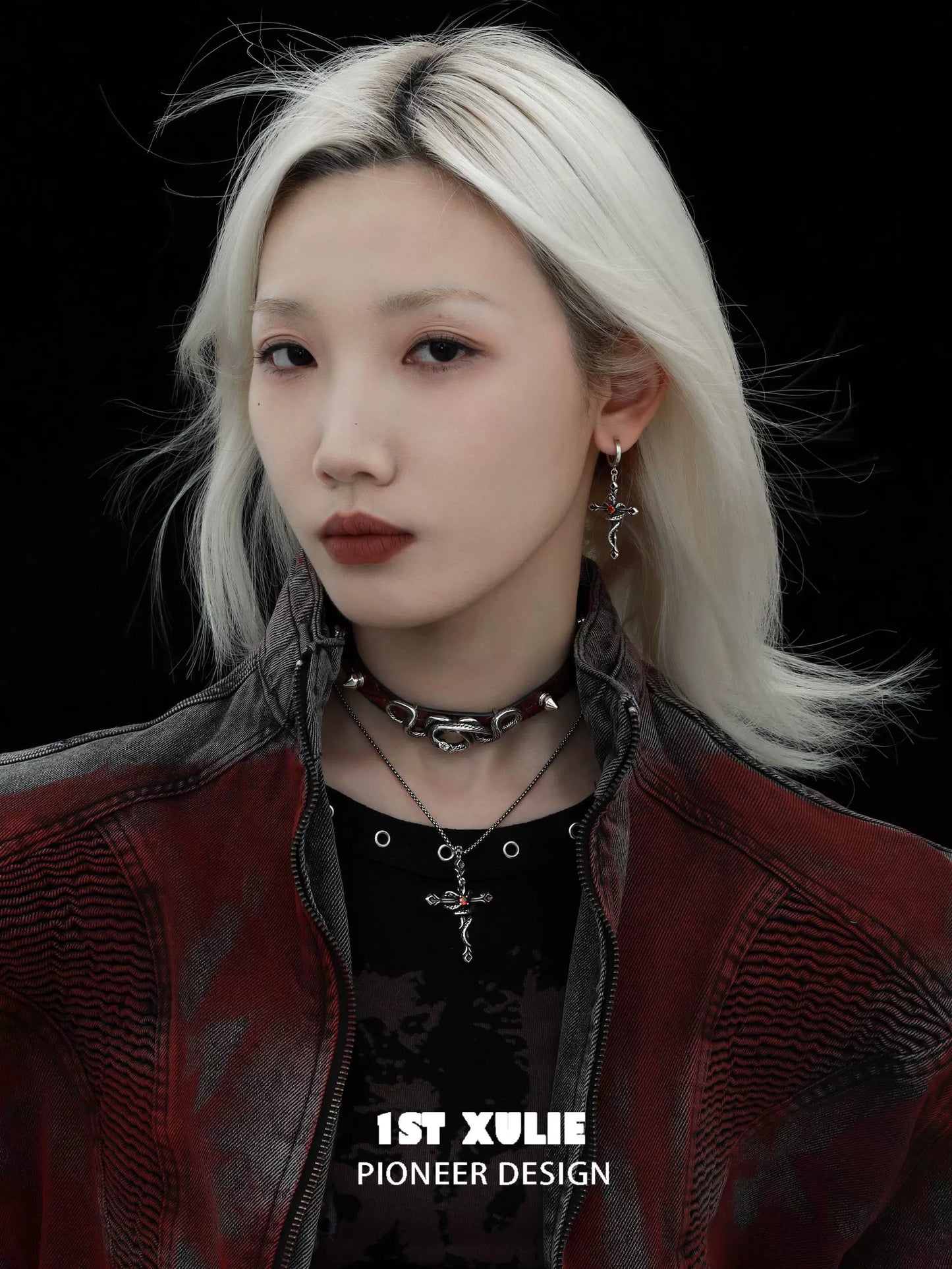 Model wearing a gothic snake necklace with matching earrings and a stylish leather jacket