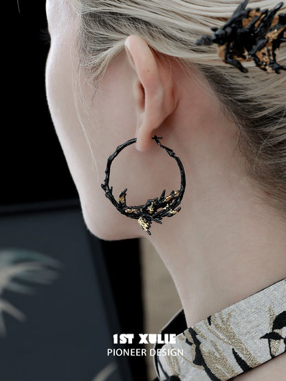 Gothic swallow earrings featuring a unique branch design with a delicate gold accent