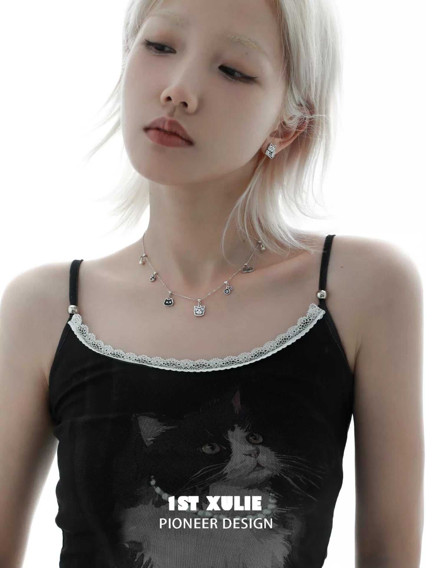Stylish graffiti cat sterling silver necklace worn by a model with a black outfit