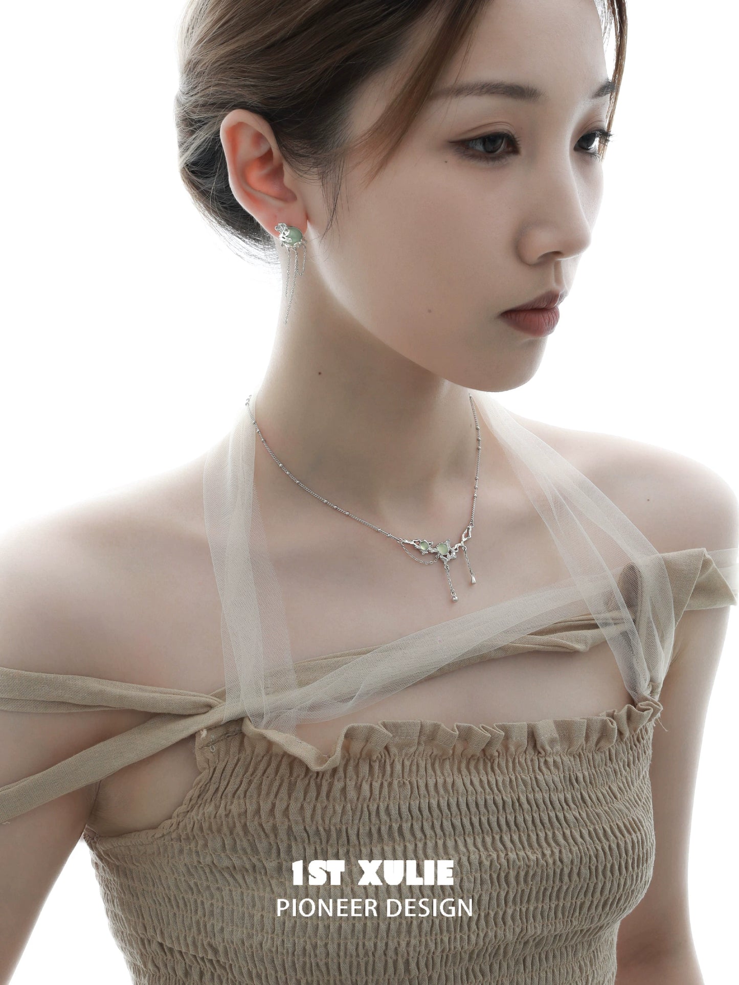 Elegant green gem silver necklace worn by a model, showcasing its unique design and sparkle
