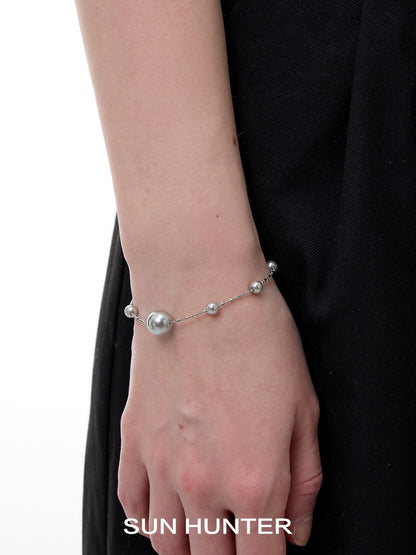 Stylish SUN HUNTER gypsy star pearl bracelet with elegant silver accents on a wrist