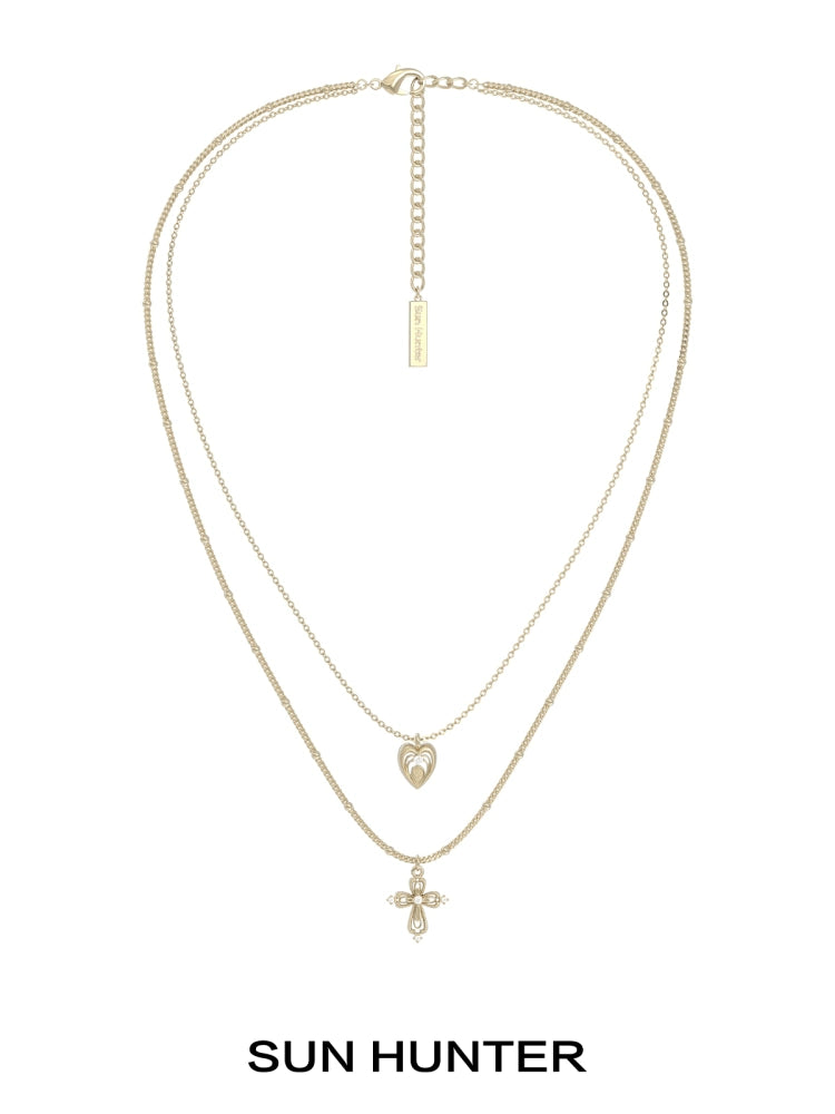 SUN HUNTER heart cross double layer necklace in gold with a heart and cross pendant