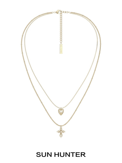 SUN HUNTER heart cross double layer necklace in gold with a heart and cross pendant