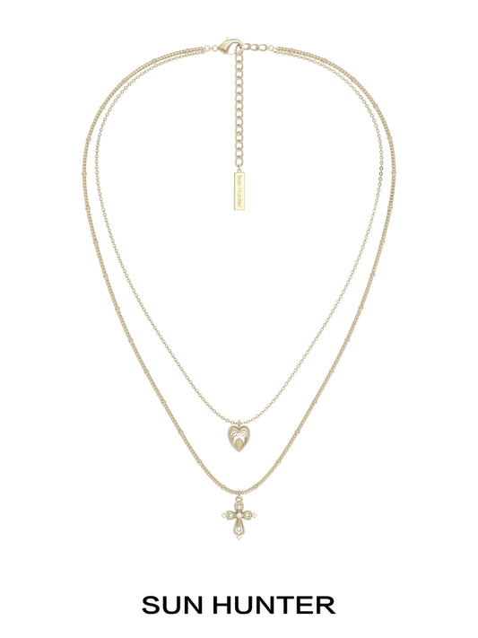 SUN HUNTER heart cross double layer necklace in gold with a heart and cross pendant