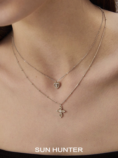 SUN HUNTER heart cross double layer necklace featuring a heart pendant and cross charm for elegant layering