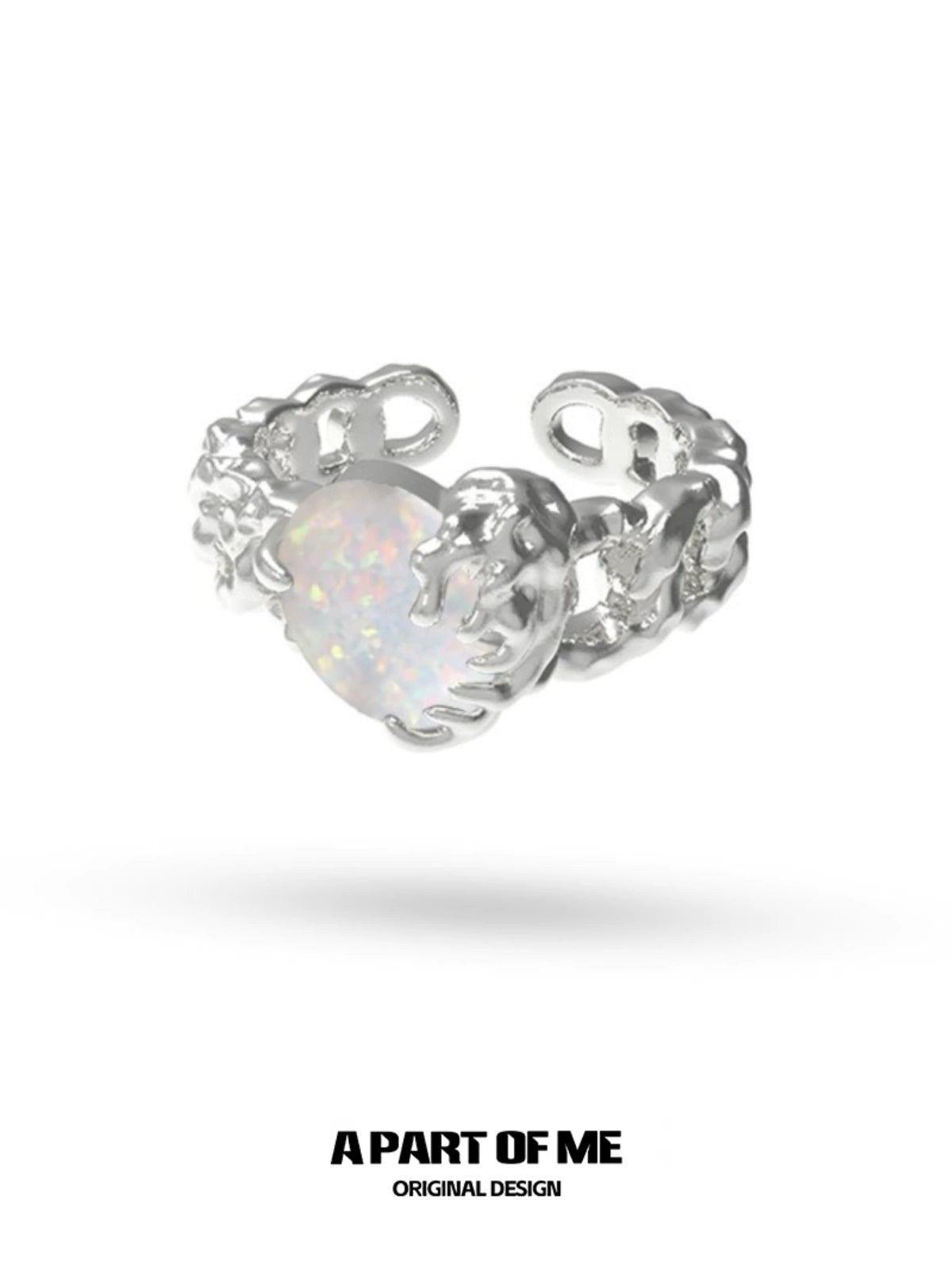 A PART OF ME heart vow ring with a silver design and an opalescent heart-shaped gemstone
