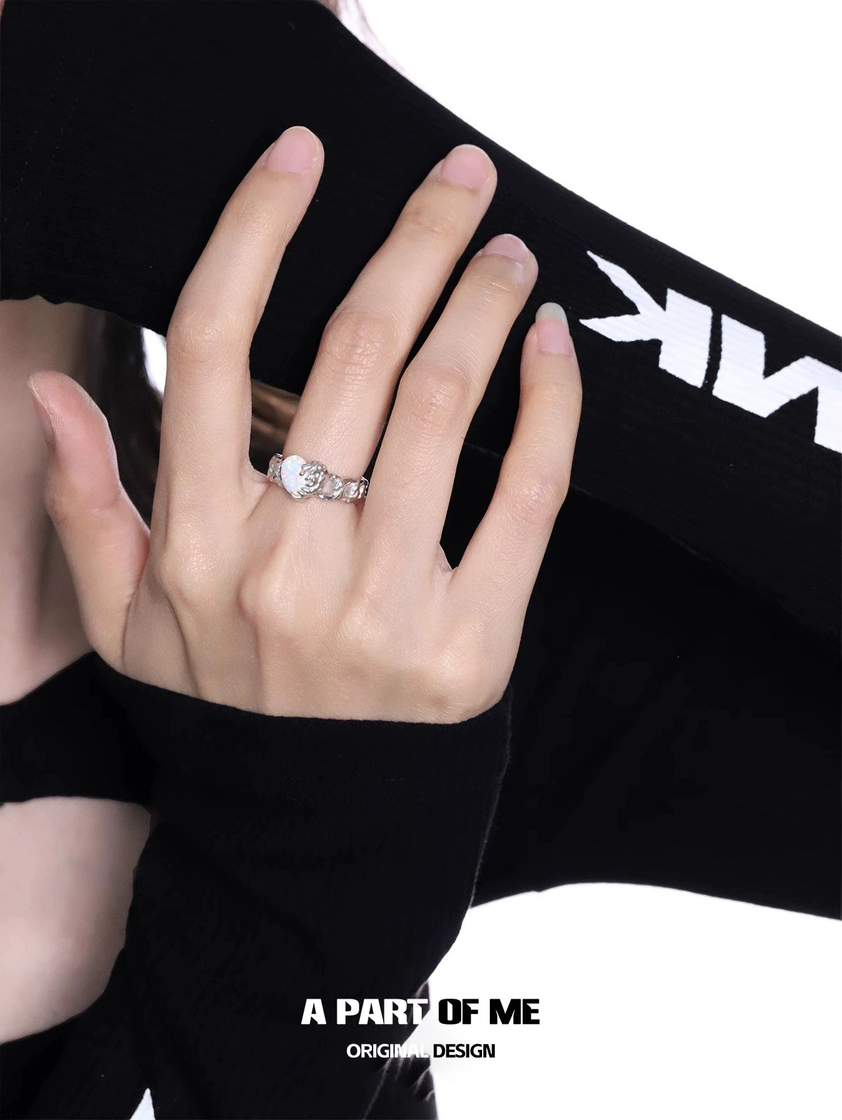 Woman wearing a heart vow ring with an elegant design on her hand, showcasing style and grace.