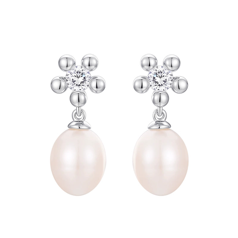 Elegant SUN HUNTER island flower pearl earrings with sparkling accents and lustrous pearls