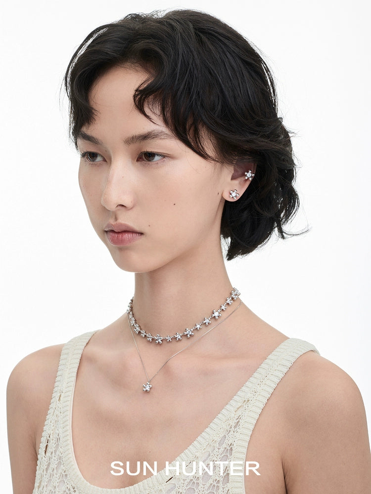 Model wearing island flower silver earrings with a matching necklace for a stylish look