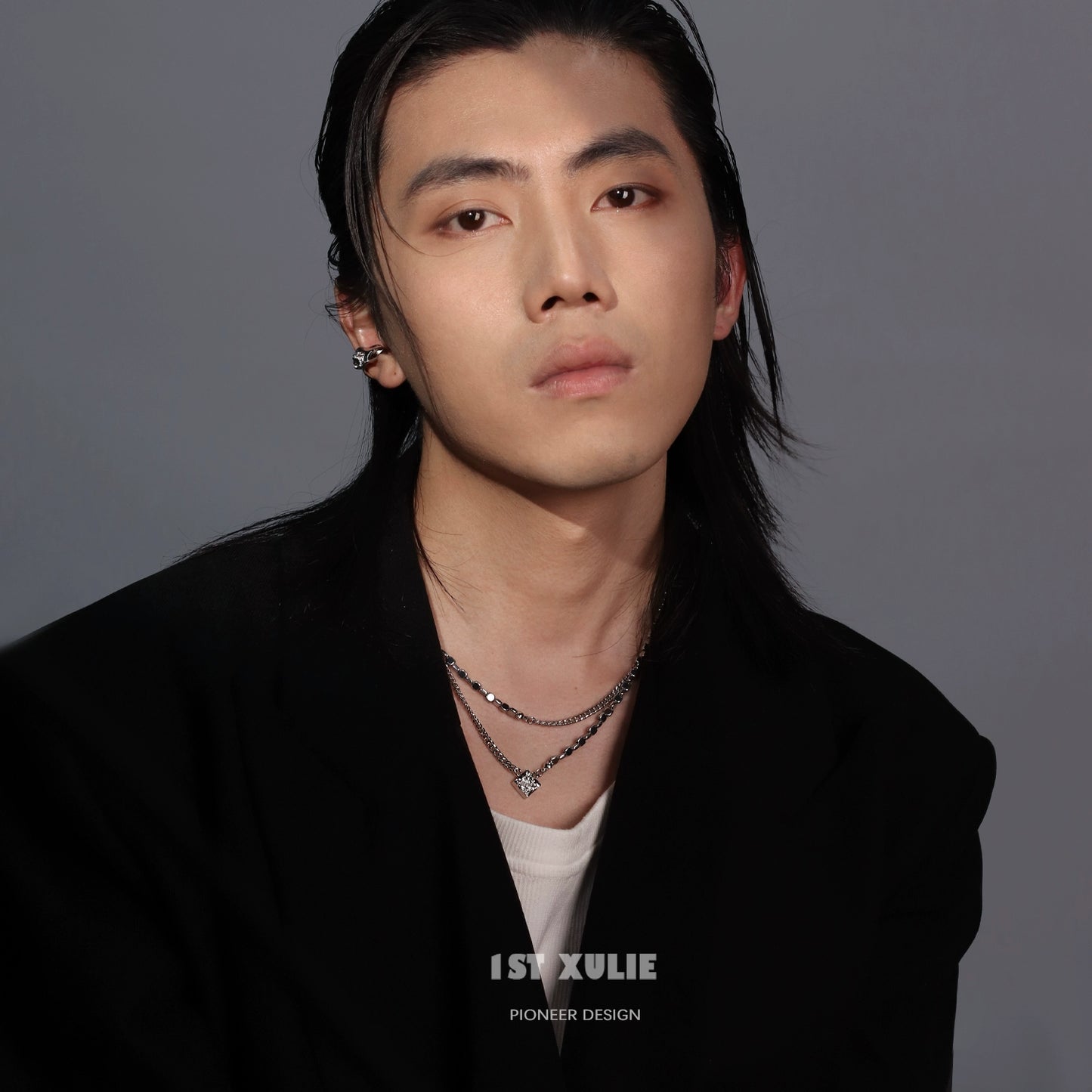 Trendy model wearing a Y2K punk necklace layered with silver chains and charms for a bold look