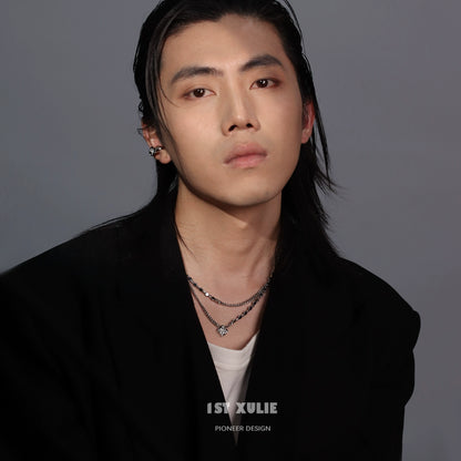 Trendy model wearing a Y2K punk necklace layered with silver chains and charms for a bold look