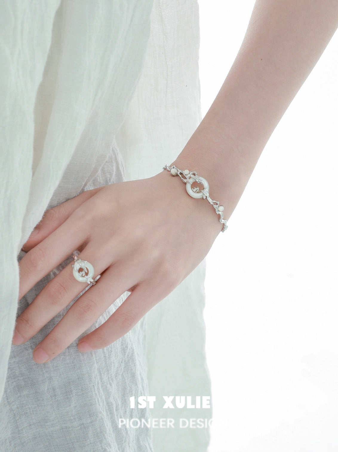 Elegant jade rabbit white agate silver bracelet showcased on wrist with matching ring from 1STXULIE