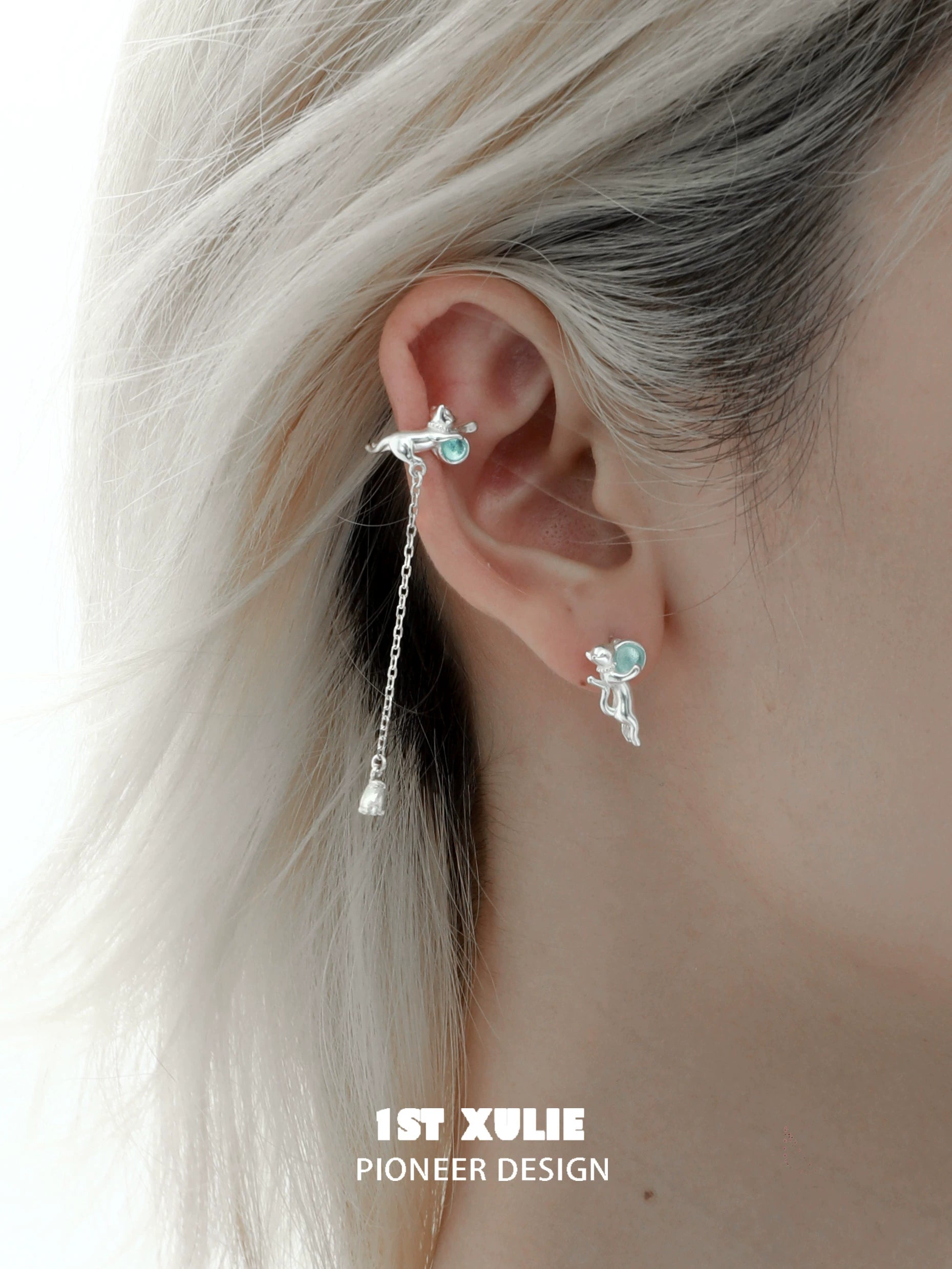 Unique kitten ear cuff jewelry featuring silver design with dangling accents and turquoise details