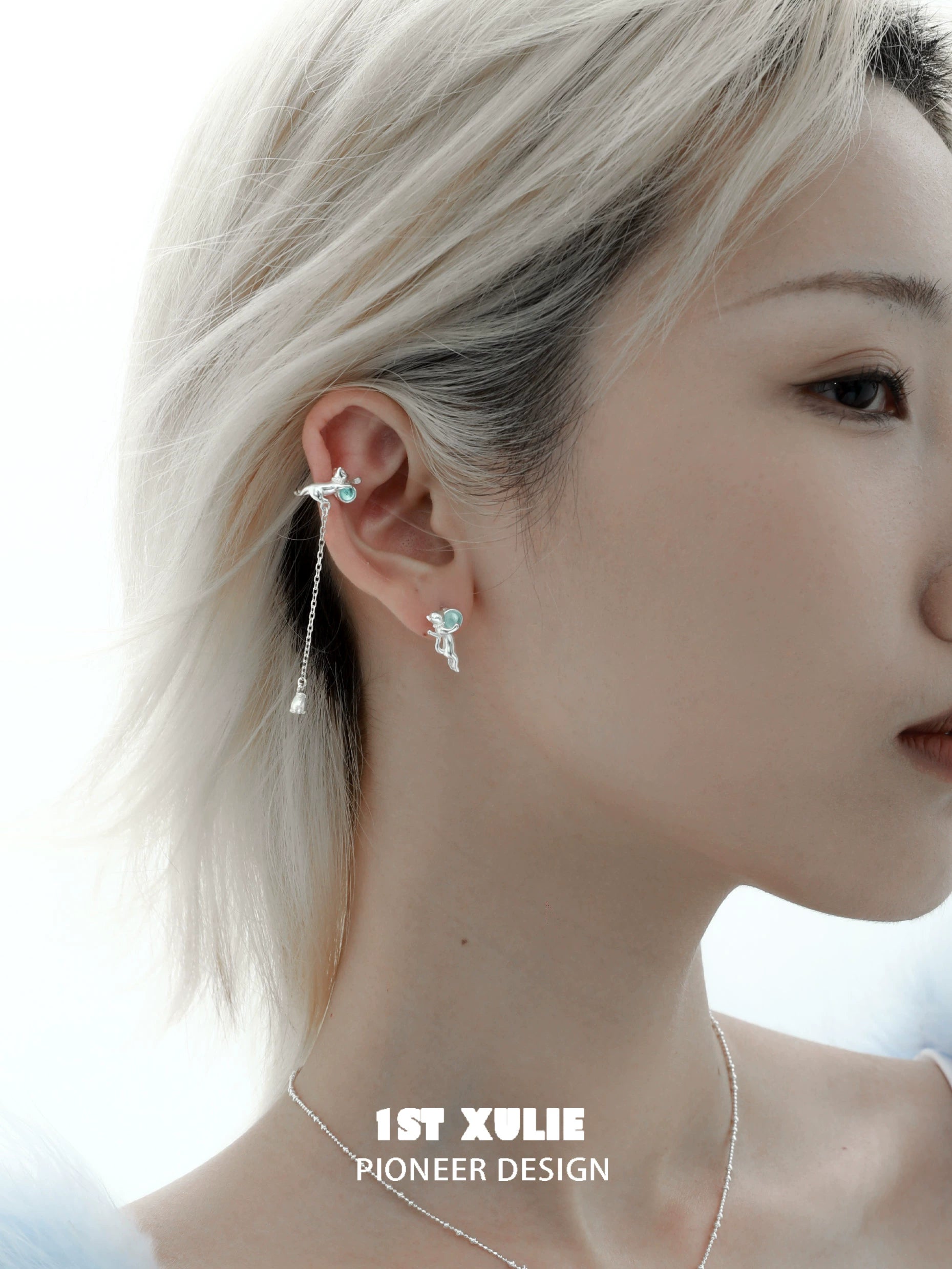 Stylish silver kitten ear cuff jewelry adorning a model's ear with a delicate design