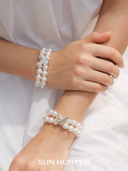 Lace butterfly pearl bracelet by SUN HUNTER featuring elegant pearl beads and butterfly charms