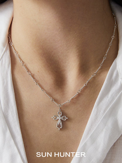 Silver SUN HUNTER lace cross necklace featuring a delicate design and sparkling accents