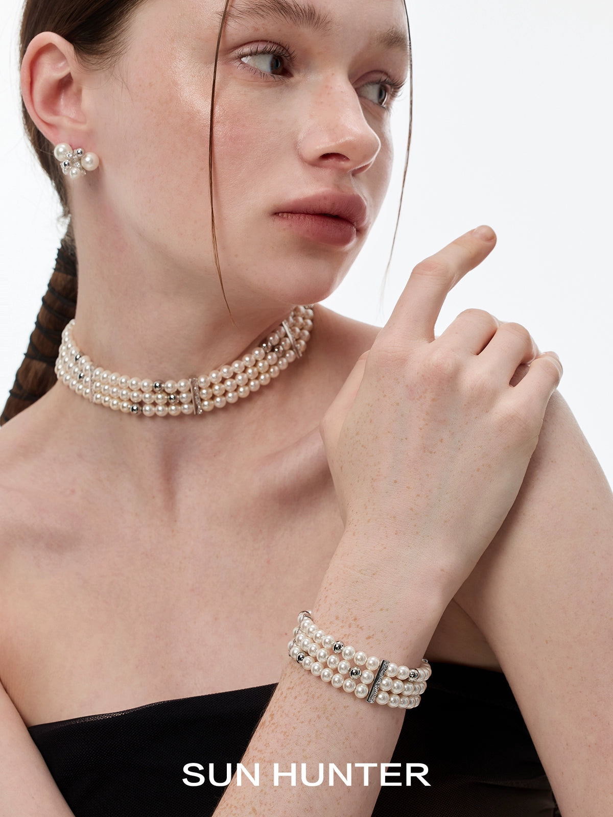 Elegant layered pearl bracelet by SUN HUNTER paired with matching pearl jewelry for a chic look