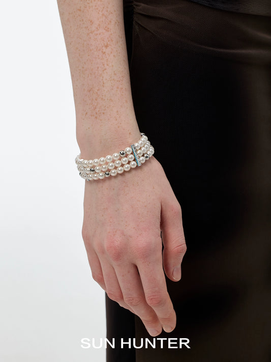 Elegant layered pearl bracelet from SUN HUNTER with multiple strands for a sophisticated look
