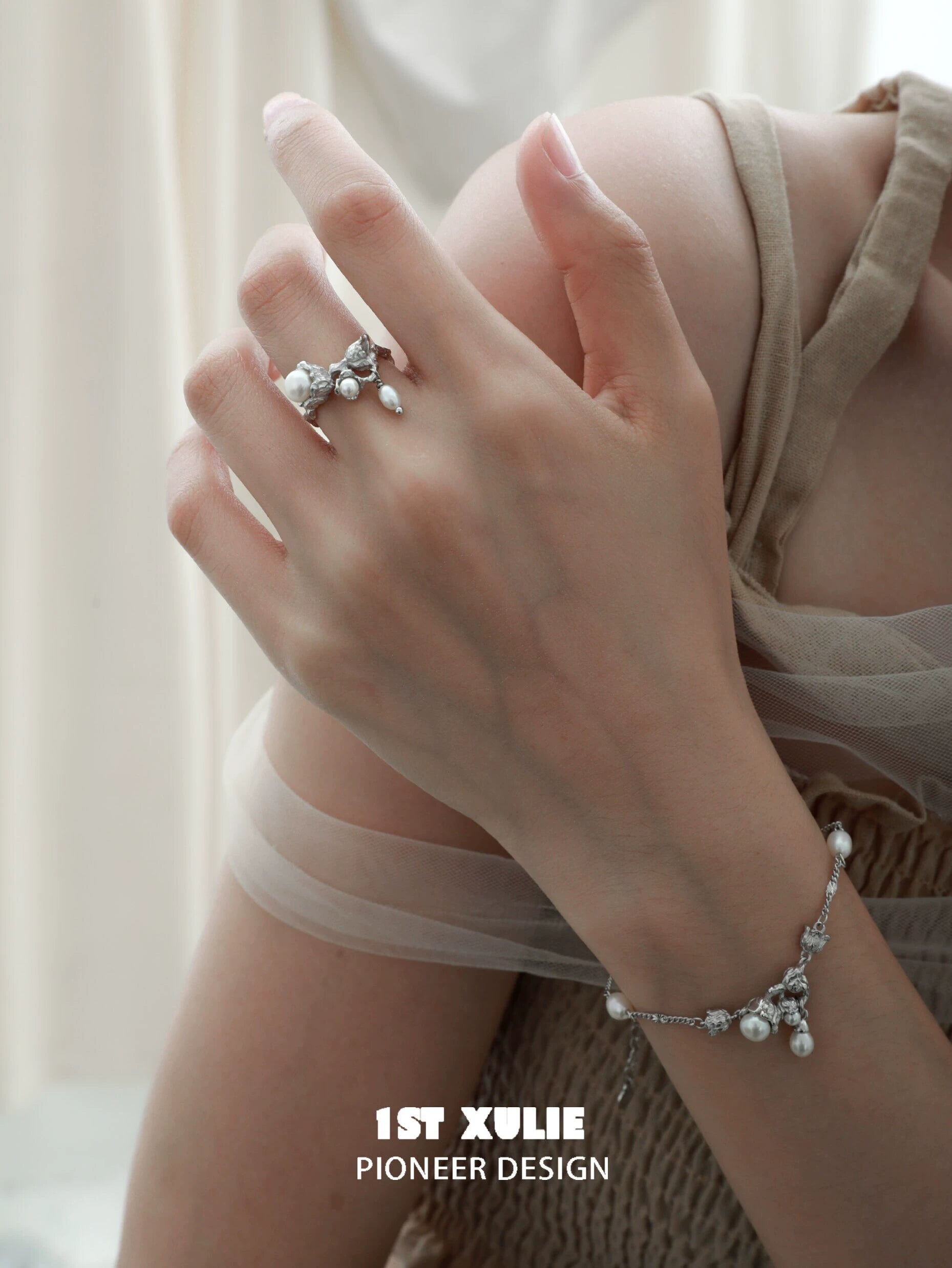 Lily of the valley pearl bracelet showcased on a delicate wrist, complementing elegant fashion.