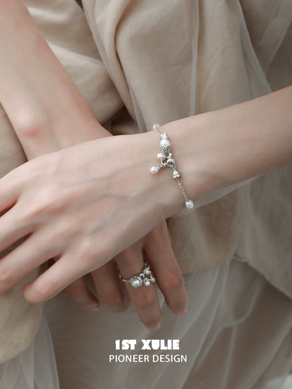 Elegant lily of the valley pearl bracelet featuring delicate floral designs and shimmering pearls
