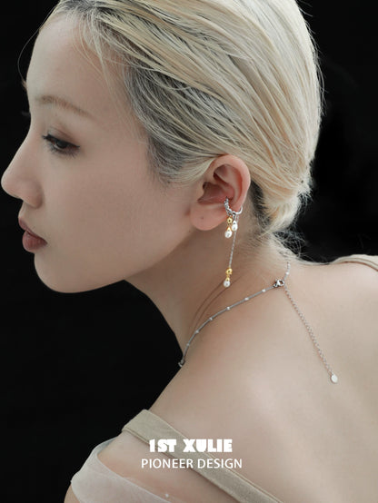 Lily tassel pearl ear cuff by 1STXULIE showcased on a model's ear with elegant design