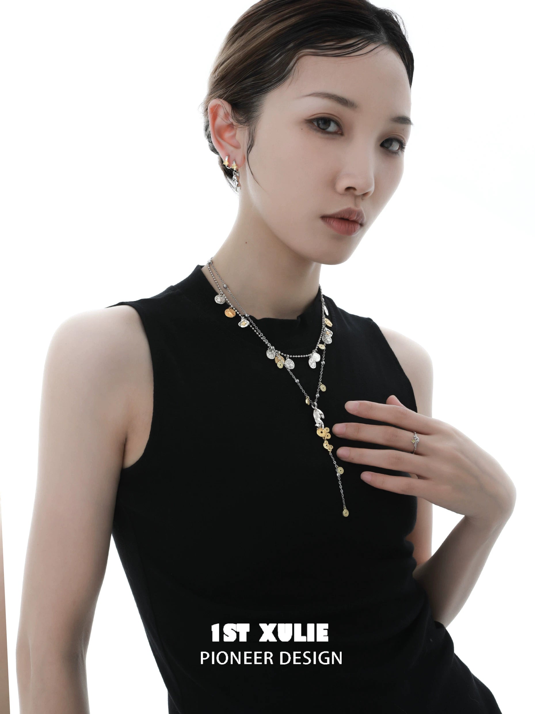 Stylish model wearing a lucky cat charm necklace with gold accents and layered design