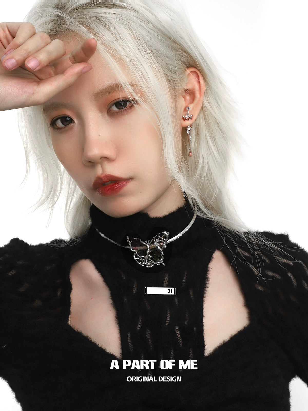 Model wearing a mechanical butterfly necklace with a sleek design and silver accents