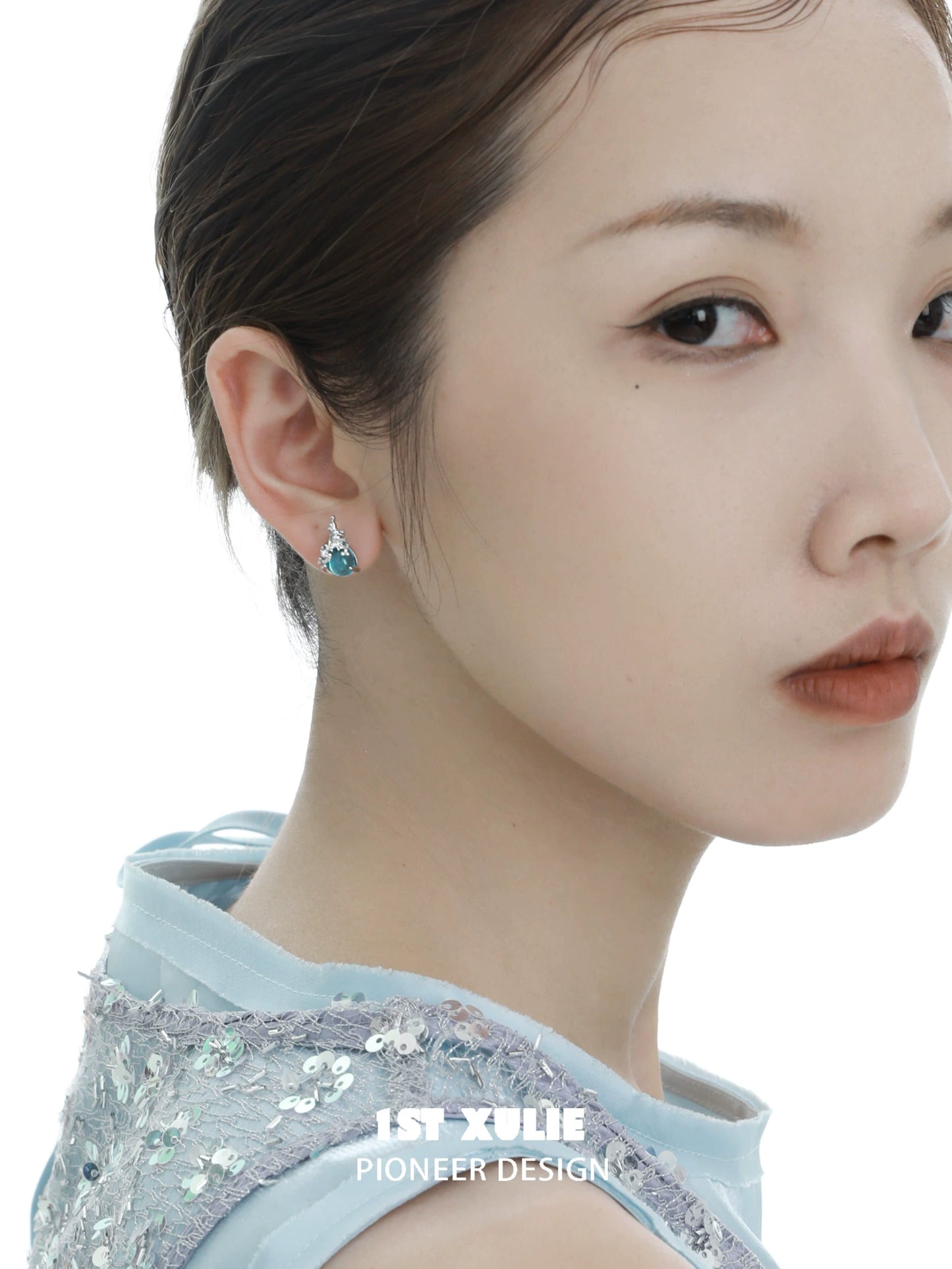 Stylish mermaid tear earrings by 1STXULIE worn by a model for a chic look