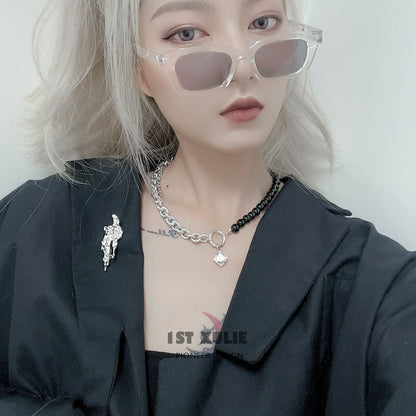 Stylish model wearing a meteorite silver brooch on a black outfit with sunglasses